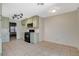 Bright kitchen with mint cabinets, black appliances, and tile floor at 7719 Selby Ct, Las Vegas, NV 89147