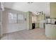 Light filled kitchen with mint cabinets, black appliances, and tile flooring at 7719 Selby Ct, Las Vegas, NV 89147