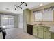 View of kitchen leading to fenced-in backyard, stainless steel sink, and tile flooring at 7719 Selby Ct, Las Vegas, NV 89147