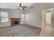 Inviting living room features a cozy brick fireplace and ceiling fan at 7719 Selby Ct, Las Vegas, NV 89147