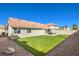 Serene backyard featuring green artificial turf and desert rock landscaping at 8745 Point Kathy Cir, Las Vegas, NV 89147