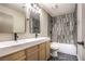 Modern bathroom featuring a double sink vanity, updated tile shower, and herringbone tile flooring at 8745 Point Kathy Cir, Las Vegas, NV 89147