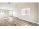 Bright bedroom showcasing wood-look tile flooring, natural light from several windows, and ample space at 8745 Point Kathy Cir, Las Vegas, NV 89147