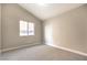 Bedroom with neutral carpet, vaulted ceiling and a window bringing in natural light at 8745 Point Kathy Cir, Las Vegas, NV 89147