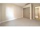 Bedroom showcasing neutral carpet, a closet with sliding doors, and great natural light at 8745 Point Kathy Cir, Las Vegas, NV 89147