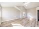 Spacious bedroom featuring wood-look tile flooring, vaulted ceiling and natural light from two windows at 8745 Point Kathy Cir, Las Vegas, NV 89147