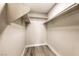 Walk-in closet featuring ample storage space and wood-look tile flooring at 8745 Point Kathy Cir, Las Vegas, NV 89147