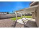 Covered patio has desert landscaping and synthetic grass at 8745 Point Kathy Cir, Las Vegas, NV 89147