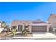 Charming single-story home showcasing a desert landscaped front yard and a two-car garage at 8745 Point Kathy Cir, Las Vegas, NV 89147