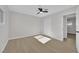 Light-filled bedroom with wood-look flooring, neutral walls, ceiling fan, and closet, creating a serene space at 905 Antelope Way, Las Vegas, NV 89145