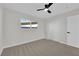 Serene bedroom with neutral carpet, a window, ceiling fan, and closet for storage and organization at 905 Antelope Way, Las Vegas, NV 89145