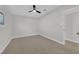 Bright bedroom featuring neutral carpet and paint, ceiling fan, and ensuite bathroom at 905 Antelope Way, Las Vegas, NV 89145