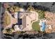 Aerial view showcasing the backyard pool with meticulous landscaping, backyard lawn, and driveway, highlighting the property's layout at 9631 Orient Express Ct, Las Vegas, NV 89145