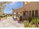 Outdoor kitchen area with grill, tiled patio and manicured landscaping for stylish outdoor living at 9631 Orient Express Ct, Las Vegas, NV 89145