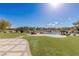 Serene backyard with a pool, lush lawn, and comfortable lounge chairs, ideal for relaxation and outdoor enjoyment at 9631 Orient Express Ct, Las Vegas, NV 89145