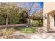 Backyard putting green for golf enthusiasts, surrounded by desert landscaping and refined patio design at 9631 Orient Express Ct, Las Vegas, NV 89145