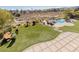 An aerial shot features a well-maintained backyard with a lush lawn, lounge chairs, and a sparkling pool at 9631 Orient Express Ct, Las Vegas, NV 89145