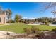 Expansive backyard featuring pristine green lawn, outdoor seating, and water features, ideal for relaxation at 9631 Orient Express Ct, Las Vegas, NV 89145