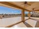 Expansive covered balcony features tiled flooring and ceiling fans, offering scenic views of the surrounding landscape at 9631 Orient Express Ct, Las Vegas, NV 89145