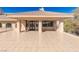 A covered balcony shows tile flooring, support columns, ceiling fans and black trimmed windows and doors at 9631 Orient Express Ct, Las Vegas, NV 89145