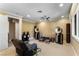 Bedroom includes a ceiling fan, recliner chair and views out a bright window at 9631 Orient Express Ct, Las Vegas, NV 89145