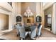 Elegant dining room with a modern chandelier, built-in cabinets, and seamless flow into the adjacent living spaces at 9631 Orient Express Ct, Las Vegas, NV 89145