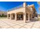 A stunning home exterior features an expansive patio, neutral colors and black trimmed windows and doors at 9631 Orient Express Ct, Las Vegas, NV 89145