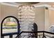 Staircase and chandelier with a view from the upper level of a luxury home at 9631 Orient Express Ct, Las Vegas, NV 89145