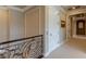 Hallway with a decorative wrought iron railing and doorways on both sides at 9631 Orient Express Ct, Las Vegas, NV 89145