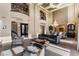 Bright living room featuring high ceilings, elegant furnishings, and natural light streaming through expansive windows at 9631 Orient Express Ct, Las Vegas, NV 89145