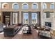 Sunlit living room featuring tall windows, a cozy fireplace, and stylish furniture arranged for comfort and elegance at 9631 Orient Express Ct, Las Vegas, NV 89145