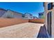 Generous backyard with dirt and a brick privacy wall, ready for personalization and landscaping at 10246 Bloom Quick Ct, Las Vegas, NV 89141