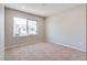 Bedroom features neutral carpet, a large window, and fresh paint at 10246 Bloom Quick Ct, Las Vegas, NV 89141