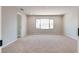 Well-lit bedroom features a large window and neutral carpet flooring at 10246 Bloom Quick Ct, Las Vegas, NV 89141