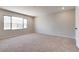 Spacious bedroom features neutral carpet, a large window, and fresh paint at 10246 Bloom Quick Ct, Las Vegas, NV 89141