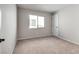 Cozy bedroom featuring neutral carpet, a large window, and fresh paint at 10246 Bloom Quick Ct, Las Vegas, NV 89141