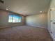 Spacious carpeted bedroom featuring neutral walls and large bright window at 10246 Bloom Quick Ct, Las Vegas, NV 89141