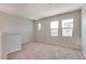 Upstairs room features natural light from the multiple windows and neutral carpet flooring at 10246 Bloom Quick Ct, Las Vegas, NV 89141