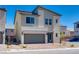 Modern two-story home featuring a two-car garage, a brick driveway, and low-maintenance landscaping at 10246 Bloom Quick Ct, Las Vegas, NV 89141