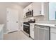 The kitchen features stainless steel appliances and sleek white cabinetry for a clean look at 10246 Bloom Quick Ct, Las Vegas, NV 89141