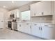 Modern kitchen showcases white cabinets, stainless steel appliances, and light countertops at 10246 Bloom Quick Ct, Las Vegas, NV 89141