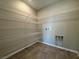 Well-equipped laundry room featuring tile floors and ample metal shelving at 10246 Bloom Quick Ct, Las Vegas, NV 89141