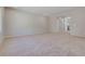 Spacious living room featuring carpeted floors, light gray walls, and an open floor plan at 10246 Bloom Quick Ct, Las Vegas, NV 89141