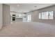 Open-concept space with a living room and kitchen featuring carpeted floors and gray walls at 10246 Bloom Quick Ct, Las Vegas, NV 89141