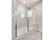 Modern walk-in shower with glass door and marble-look shower surround at 10246 Bloom Quick Ct, Las Vegas, NV 89141