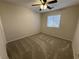 Cozy carpeted bedroom with ceiling fan and a bright window at 10321 Birch Bluff Ln, Las Vegas, NV 89145