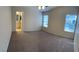 Bright bedroom with neutral carpet, two windows and ceiling fan at 10321 Birch Bluff Ln, Las Vegas, NV 89145