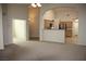 Open floor plan view from living room into kitchen with eat in breakfast bar at 10321 Birch Bluff Ln, Las Vegas, NV 89145