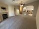 Open-concept living room flows into the kitchen, featuring neutral carpet at 10321 Birch Bluff Ln, Las Vegas, NV 89145