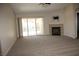 Spacious living room showcasing a fireplace and sliding doors to the backyard at 10321 Birch Bluff Ln, Las Vegas, NV 89145